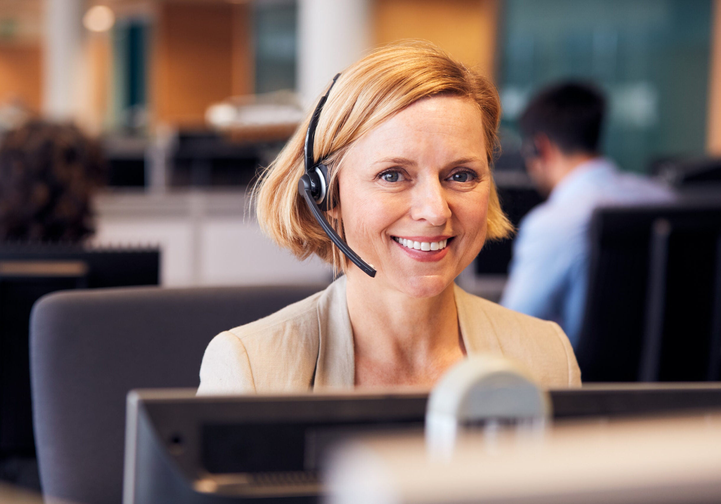 Portrait Of Mature Businesswoman Wearing Telephone Headset Working In Customer Services Department women in customer service